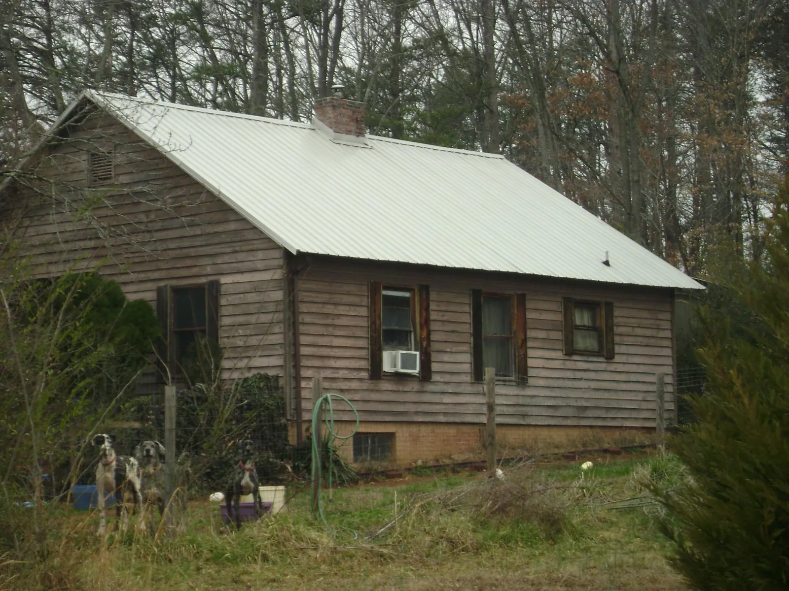 White metal roof on an old wood sided farmhouse, from a Metal Roof Installation job in Ipswich